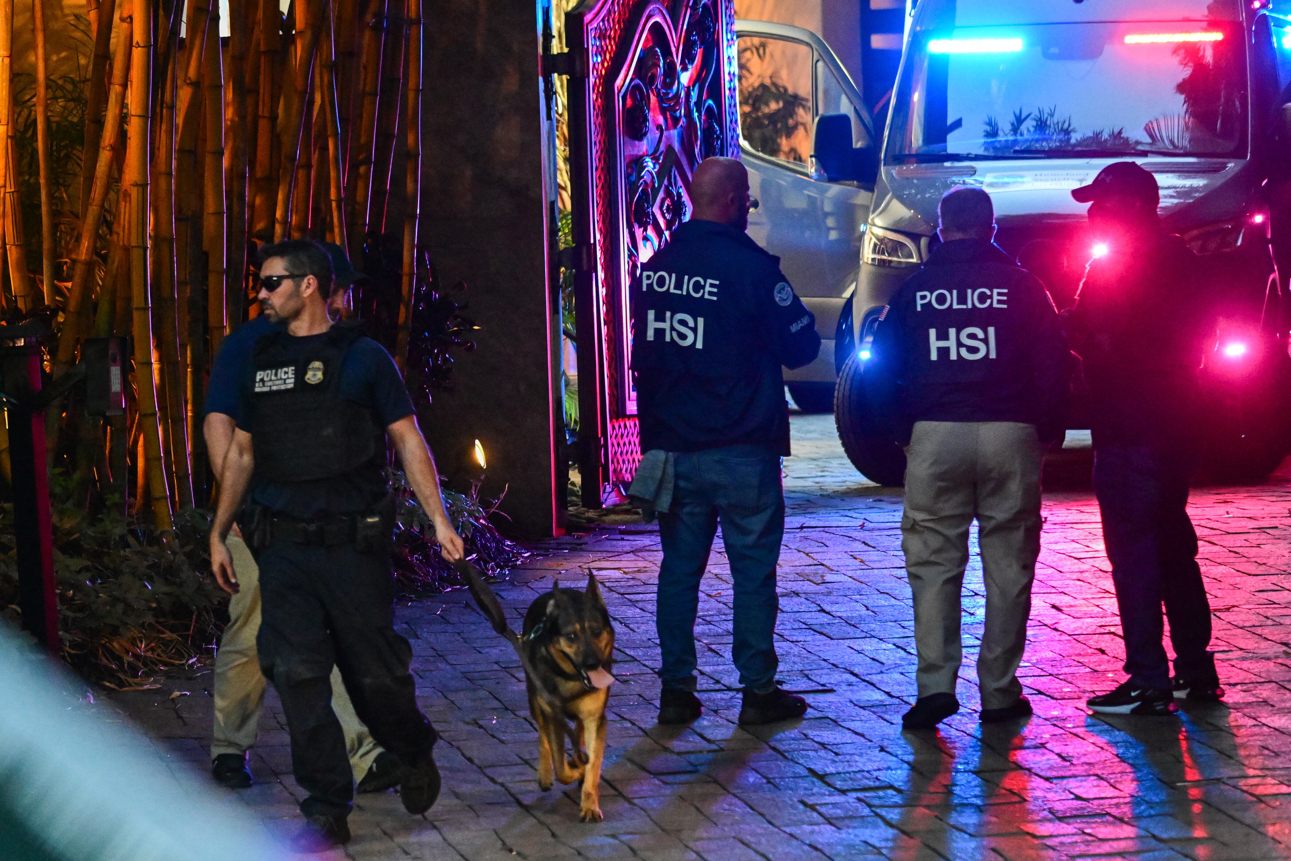 Homeland Security Investigation agents are seen at the entrance of US producer and musician Sean "Diddy" Combs's home at Star Island in Miami Beach on March 25, 2024. Homes belonging to Sean "Diddy" Combs were being raided by federal agents, media reported on March 25, with the US hip hop mogul at the center of sex trafficking and sex assault lawsuits. (Photo by GIORGIO VIERA / AFP) (Photo by GIORGIO VIERA/AFP via Getty Images)