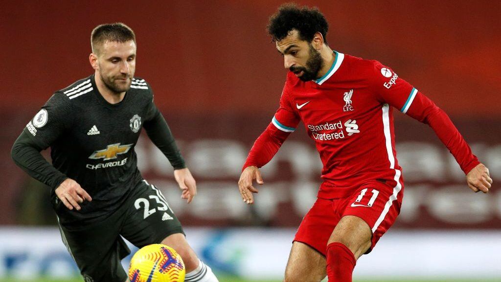 Manchester United's English defender Luke Shaw (L) vies with Liverpool's Egyptian midfielder Mohamed Salah during the English Premier League football match between Liverpool and Manchester United at Anfield in Liverpool, north west England on January 17, 2021. (Photo by PHIL NOBLE / POOL / AFP) / RESTRICTED TO EDITORIAL USE. No use with unauthorized audio, video, data, fixture lists, club/league logos or 'live' services. Online in-match use limited to 120 images. An additional 40 images may be used in extra time. No video emulation. Social media in-match use limited to 120 images. An additional 40 images may be used in extra time. No use in betting publications, games or single club/league/player publications. /  (Photo by PHIL NOBLE/POOL/AFP via Getty Images)