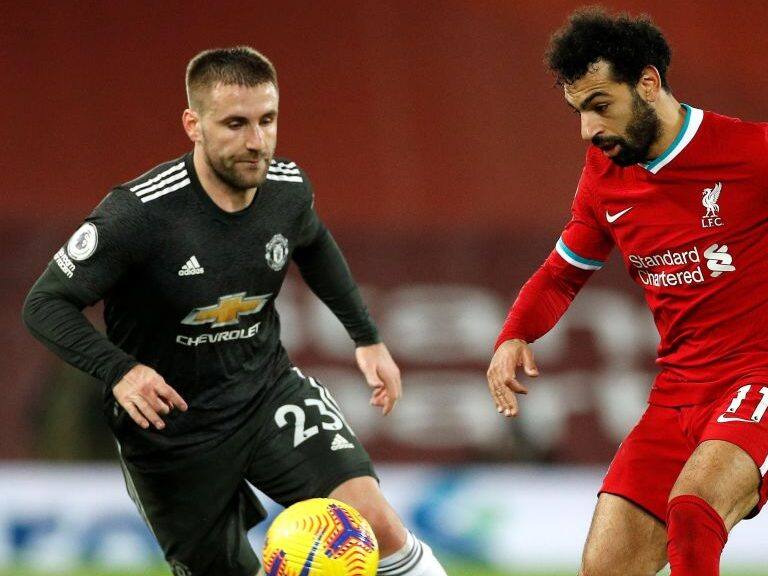 Manchester United&#039;s English defender Luke Shaw (L) vies with Liverpool&#039;s Egyptian midfielder Mohamed Salah during the English Premier League football match between Liverpool and Manchester United at Anfield in Liverpool, north west England on January 17, 2021. (Photo by PHIL NOBLE / POOL / AFP) / RESTRICTED TO EDITORIAL USE. No use with unauthorized audio, video, data, fixture lists, club/league logos or &#039;live&#039; services. Online in-match use limited to 120 images. An additional 40 images may be used in extra time. No video emulation. Social media in-match use limited to 120 images. An additional 40 images may be used in extra time. No use in betting publications, games or single club/league/player publications. /  (Photo by PHIL NOBLE/POOL/AFP via Getty Images)