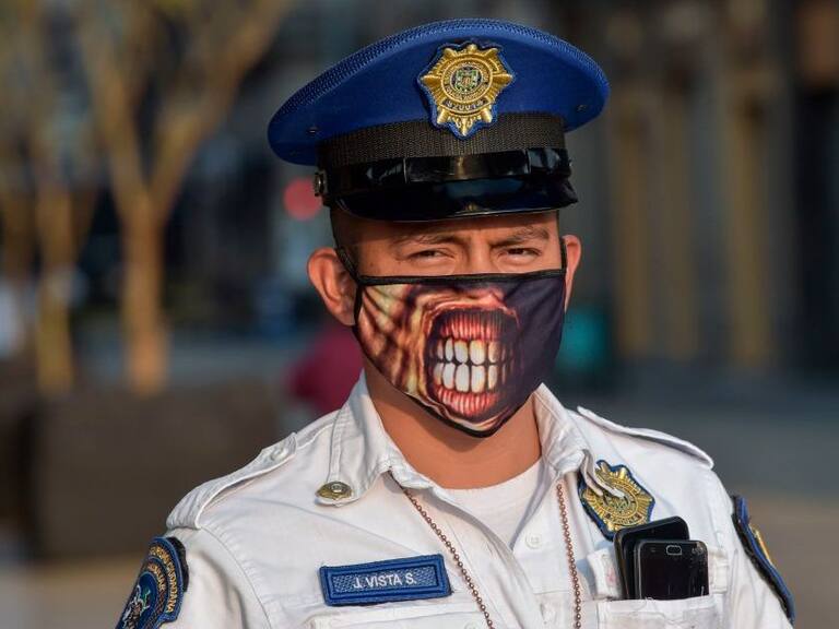 A police man wears a face mask as he stands at the closed Madero street next to Zocalo square in Mexico City, on April 2, 2020. - More than 20,000 cases of COVID-19 were registered in Latin America and the Caribbean by Wednesday -- double the figure from five days ago, according to an AFP tally. (Photo by PEDRO PARDO / AFP) (Photo by PEDRO PARDO/AFP via Getty Images)