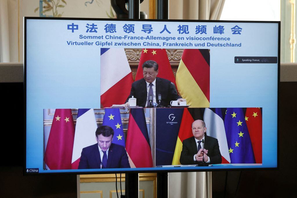 A video screen displays French President Emmanuel Macron (bottom, left), German Chancellor Olaf Scholz (bottom, right) and Chinese President Xi Jinping (up) attending a video-conference to discuss the Ukraine crisis, at the Elysee Palace in Paris, on March 8, 2022. (Photo by BENOIT TESSIER / POOL / AFP) (Photo by BENOIT TESSIER/POOL/AFP via Getty Images)