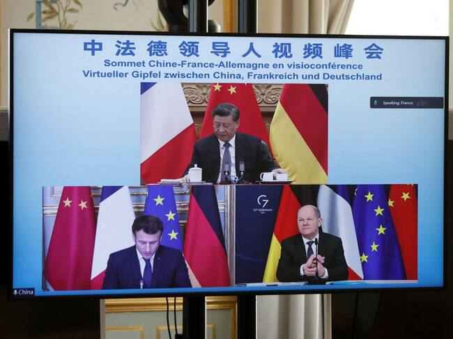 A video screen displays French President Emmanuel Macron (bottom, left), German Chancellor Olaf Scholz (bottom, right) and Chinese President Xi Jinping (up) attending a video-conference to discuss the Ukraine crisis, at the Elysee Palace in Paris, on March 8, 2022. (Photo by BENOIT TESSIER / POOL / AFP) (Photo by BENOIT TESSIER/POOL/AFP via Getty Images)