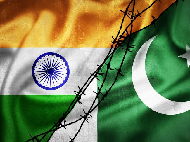 Grunge flags of India and Pakistan divided by barb wire illustration, concept of tense relations between India and Pakistan