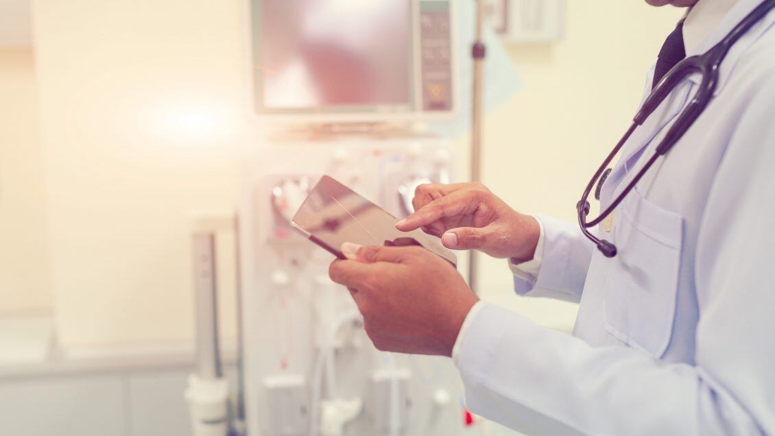 Doctor is working with tablet computer at the hospital emergency room,Multiple exposure of health care concept.