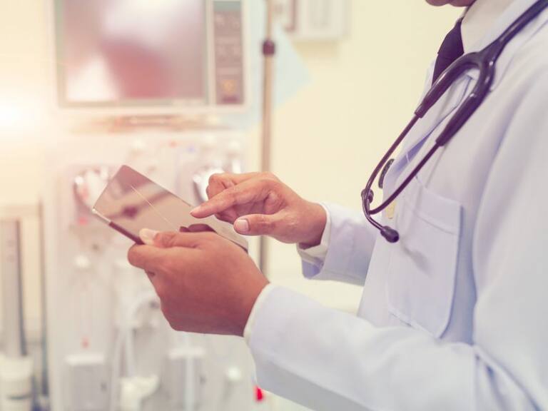 Doctor is working with tablet computer at the hospital emergency room,Multiple exposure of health care concept.