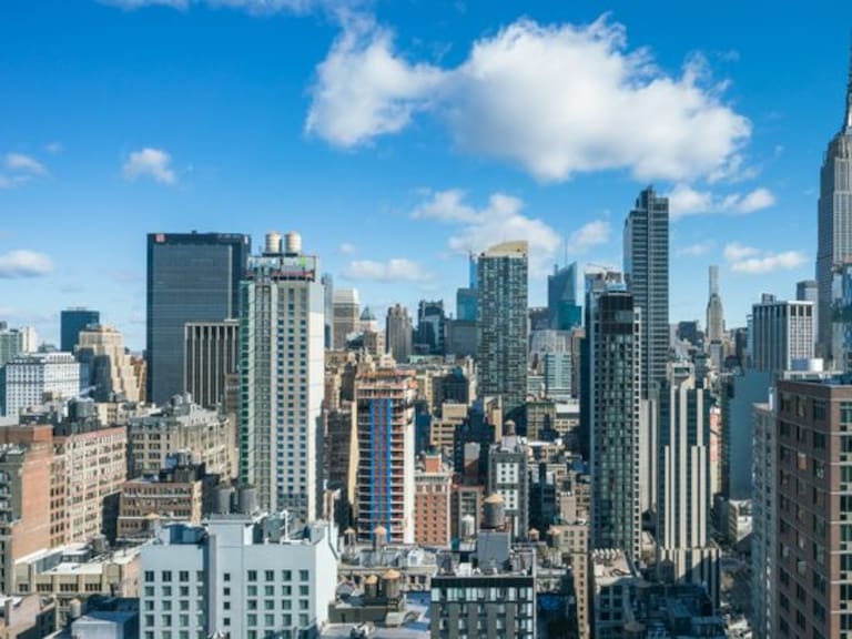 This high angle view from the Chelsea neighborhood in New York looks north toward midtown Manhattan. Some of the prominent buildings seen here are the Empire State Building, 1 Penn Plaza, and Bank of America Tower.