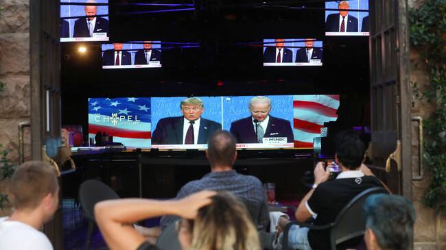 WEST HOLLYWOOD, CALIFORNIA - SEPTEMBER 29: People sit and watch a broadcast of the first debate between President Donald Trump and Democratic presidential nominee Joe Biden at The Abbey, with socially distanced outdoor seating, on September 29, 2020 in West Hollywood, California. The debate being held in Cleveland, Ohio is the first of three scheduled debates between Trump and Biden. (Photo by Mario Tama/Getty Images)
