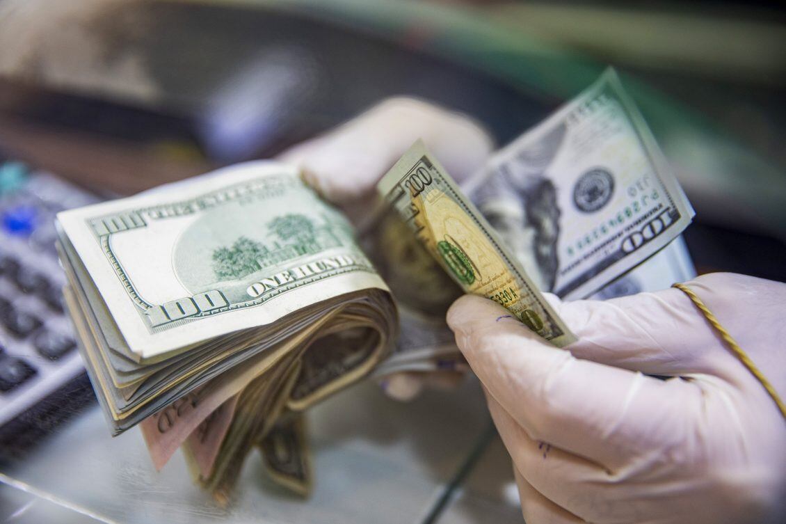 A worker counts U.S. 100 dollar banknotes in Lebanon. Photographer: Francesca Volpi/Bloomberg