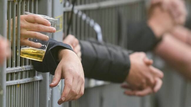 DORTMUND, GERMANY - SEPTEMBER 17: . hands of the fans with a beer behind the fence during the Bundesliga match between Borussia Dortmund and FC Schalke 04 at Signal Iduna Park on September 17, 2022 in Dortmund, Germany. (Photo by Alex Gottschalk/DeFodi Images via Getty Images)
