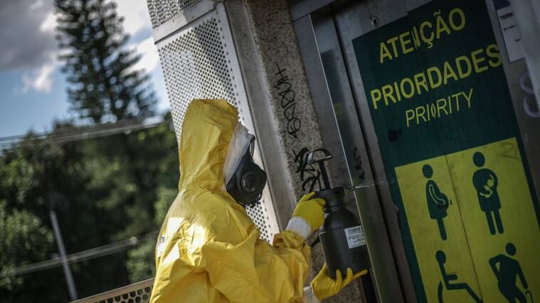 RIO DE JANEIRO, BRAZIL - MARCH 28: A Brazilian Army soldier from the 1st Nuclear, Radiological, Biological and Chemical Defense Battalion (1 BTL DQBRN) performs disinfection operations at BRT (Bus Rapid Transportation) Stations at Barra da Tijuca neighborhood due to the coronavirus (COVID - 19) pandemic on March 28, 2020 in Rio de Janeiro, Brazil. The Coronavirus (COVID-19) pandemic has spread to many countries across the world, claiming over 20,000 lives and infecting hundreds of thousands more. (Photo by Andre Coelho/Getty Images)