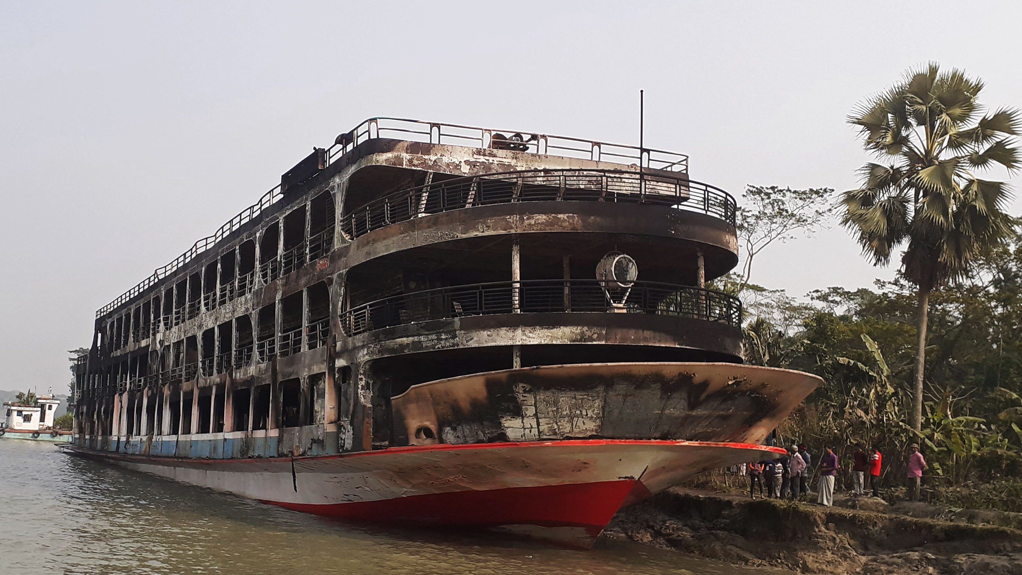 TOPSHOT - The burnt-out ferry is seen anchored along a coast a day after it caught fire killing at least 37 people in Jhalkathi, 250 km (160 miles) south of Dhaka on December 24, 2021. (Photo by arifur rahman / AFP) (Photo by ARIFUR RAHMAN/AFP via Getty Images)