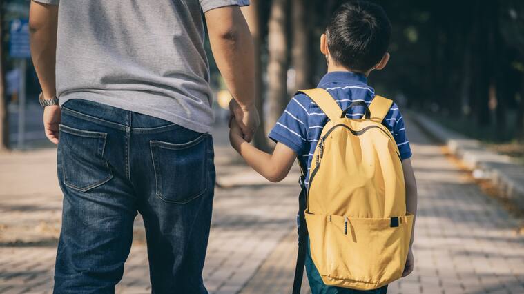 Father and son going to kindergarten