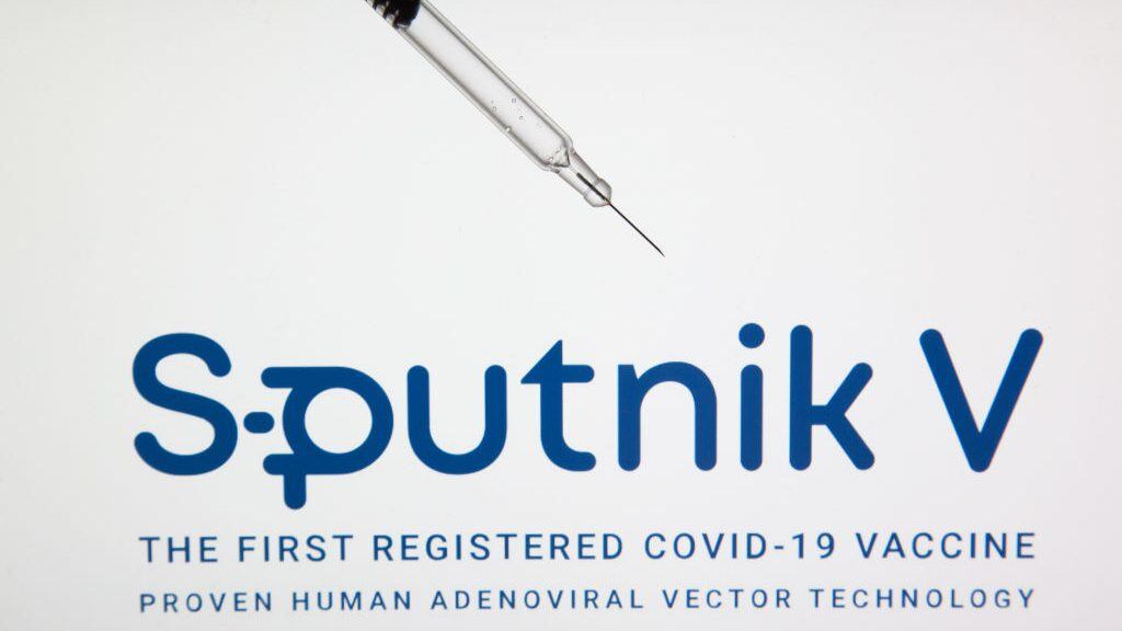GREECE - 2020/12/16: In this photo illustration, a medical syringe seen displayed in front of the Sputnik V's drug company logo. Sputnik V is the first registered covid-19 vaccine and it is Russian. (Photo Illustration by Konstantinos Zilos/SOPA Images/LightRocket via Getty Images)