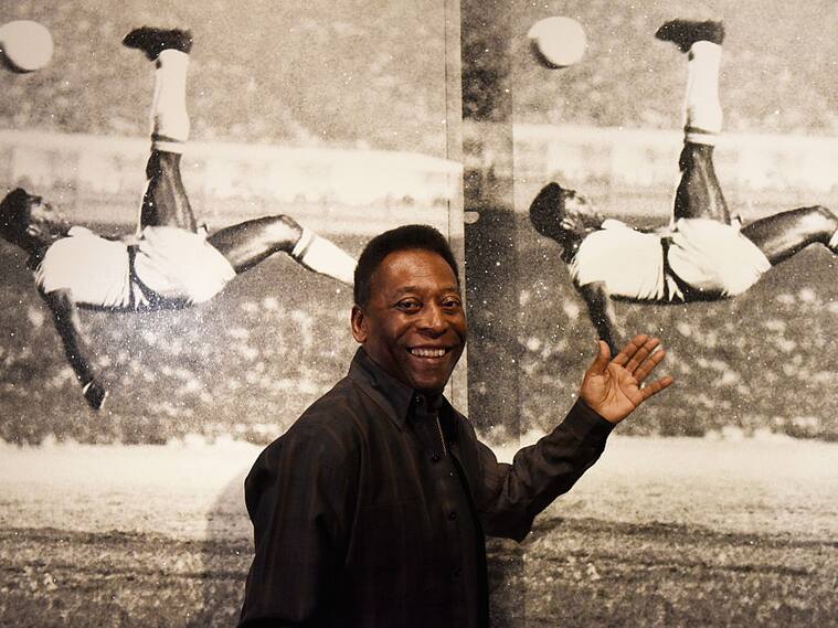 Pelé posa ante su imagen ensayando una chilena en una exposición en Londres en 2016
