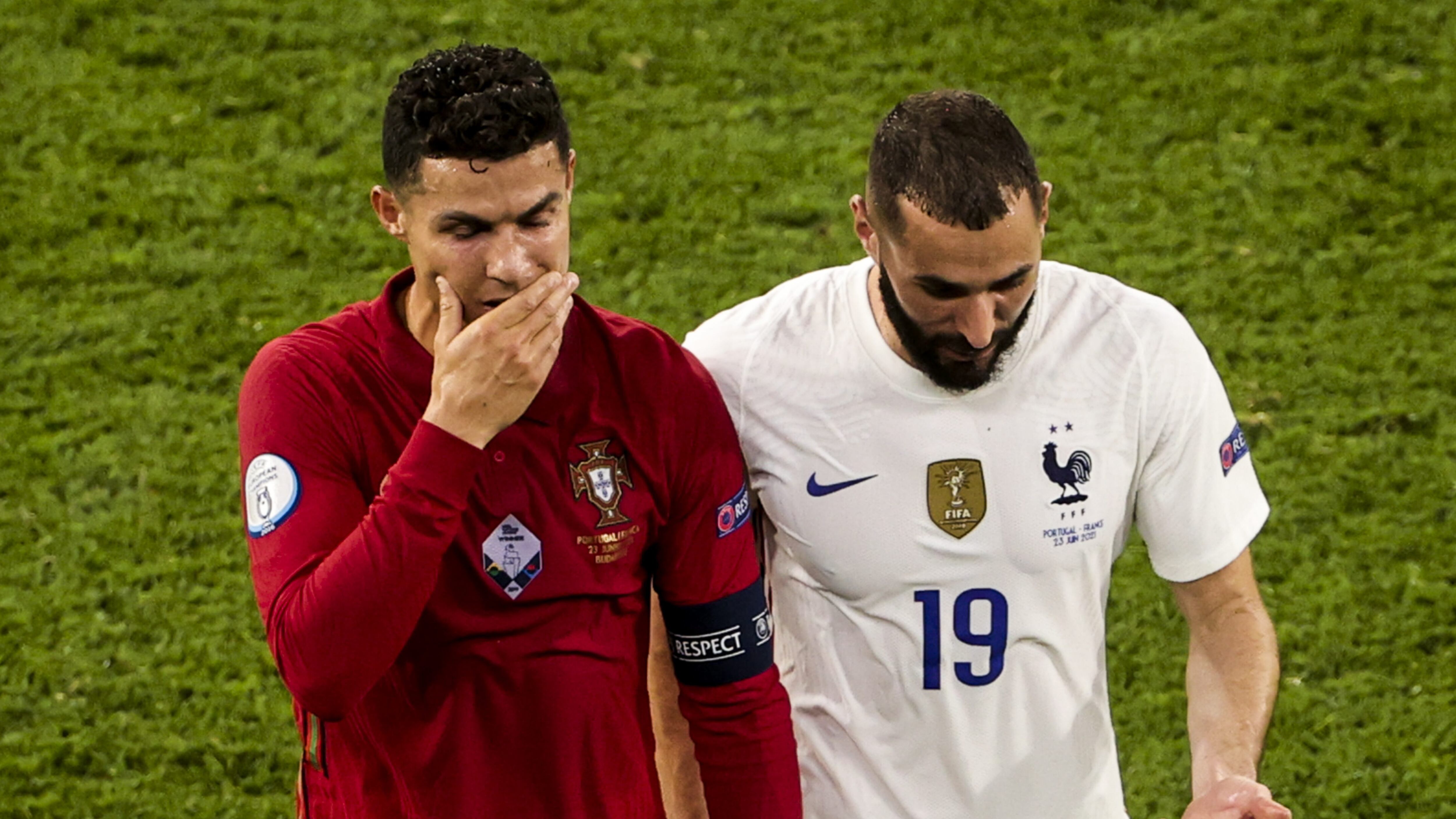 BUDAPEST, HUNGARY - JUNE 23: Cristiano Ronaldo (7) of Portugal and Karim Benzema (19) of France leave the pitch together during a break in the EURO 2020 Group F match between Portugal and France at Ferenc Puskas Stadium in Budapest, Hungary on June 23, 2021. (Photo by Dmitriy Golubovich/Anadolu Agency via Getty Images)