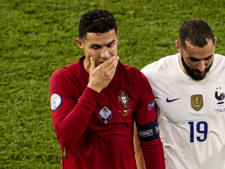 BUDAPEST, HUNGARY - JUNE 23: Cristiano Ronaldo (7) of Portugal and Karim Benzema (19) of France leave the pitch together during a break in the EURO 2020 Group F match between Portugal and France at Ferenc Puskas Stadium in Budapest, Hungary on June 23, 2021. (Photo by Dmitriy Golubovich/Anadolu Agency via Getty Images)