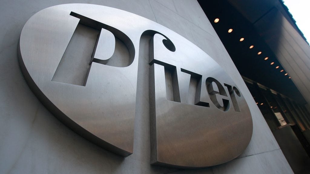 NEW YORK - JANUARY 26: A Pfizer sign hangs on the outside of their headquarters after a news conference discussing the planned merger of Pfizer and Wyeth January 26, 2009 in New York City. Pfizer plans to acquire Wyeth for $68 billion creating the world's largest biopharmaceutical company. (Photo by Mario Tama/Getty Images)