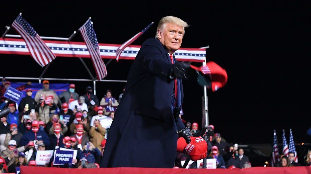 US President Donald Trump throws MAGA hats to supporters during a rally at Williamsport Regional Airport in Montoursville, Pennsylvania on October 31, 2020. (Photo by MANDEL NGAN / AFP) (Photo by MANDEL NGAN/AFP via Getty Images)