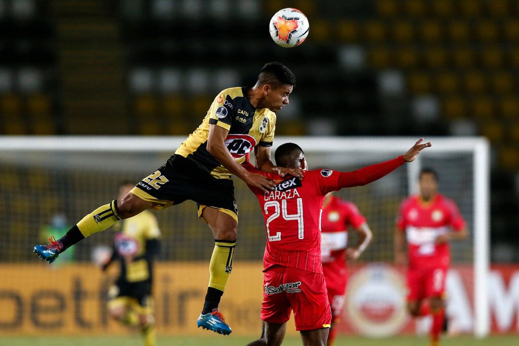 Chile's Coquimbo John Salas (L) and Peru's Sport Huancayo Carlos Caraza vie for the ball during their closed-door Copa Sudamericana round before the quarterfinals football match at the Bicentenario Francisco Sanchez Rumoroso stadium in Coquimbo, Chile, on November 25, 2020. (Photo by JAVIER TORRES / AFP) (Photo by JAVIER TORRES/AFP via Getty Images)