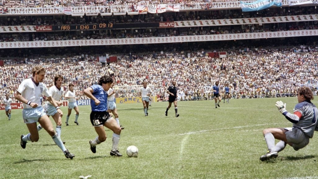 Argentinian forward Diego Armando Maradona (3rd L) runs past English defender Terry Butcher (L) on his way to dribbling goalkeeper Peter Shilton (R) and scoring his second goal, or goal of the century, during the World Cup quarterfinal soccer match between Argentina and England on June 22, 1986 in Mexico City. Argentina advanced to the semifinals with a 2-1 victory. (Photo by STAFF / AFP) (Photo by STAFF/AFP via Getty Images)