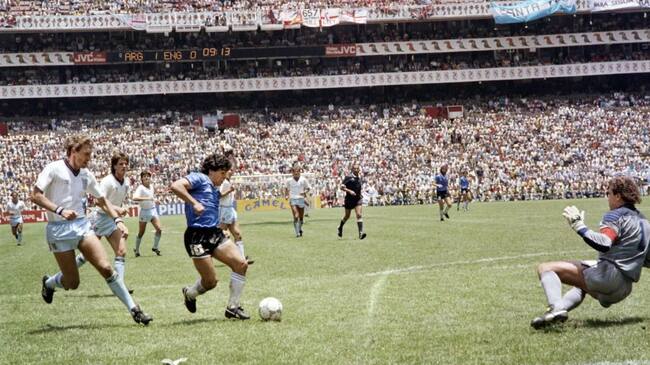 Argentinian forward Diego Armando Maradona (3rd L) runs past English defender Terry Butcher (L) on his way to dribbling goalkeeper Peter Shilton (R) and scoring his second goal, or goal of the century, during the World Cup quarterfinal soccer match between Argentina and England on June 22, 1986 in Mexico City. Argentina advanced to the semifinals with a 2-1 victory. (Photo by STAFF / AFP) (Photo by STAFF/AFP via Getty Images)