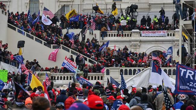 WASHINGTON, DC - JANUARY 6: Protesters take over the Inaugural stage during a protest calling for legislators to overturn the election results in President Donald Trump's favor at the U.S. Capitol on January 6, 2021 in Washington, D.C. (Photo by Ricky Carioti/The Washington Post via Getty Images)