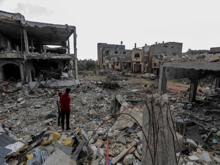 Dos palestinos observan la destrucción que provoca Israel en la Franja de Gaza