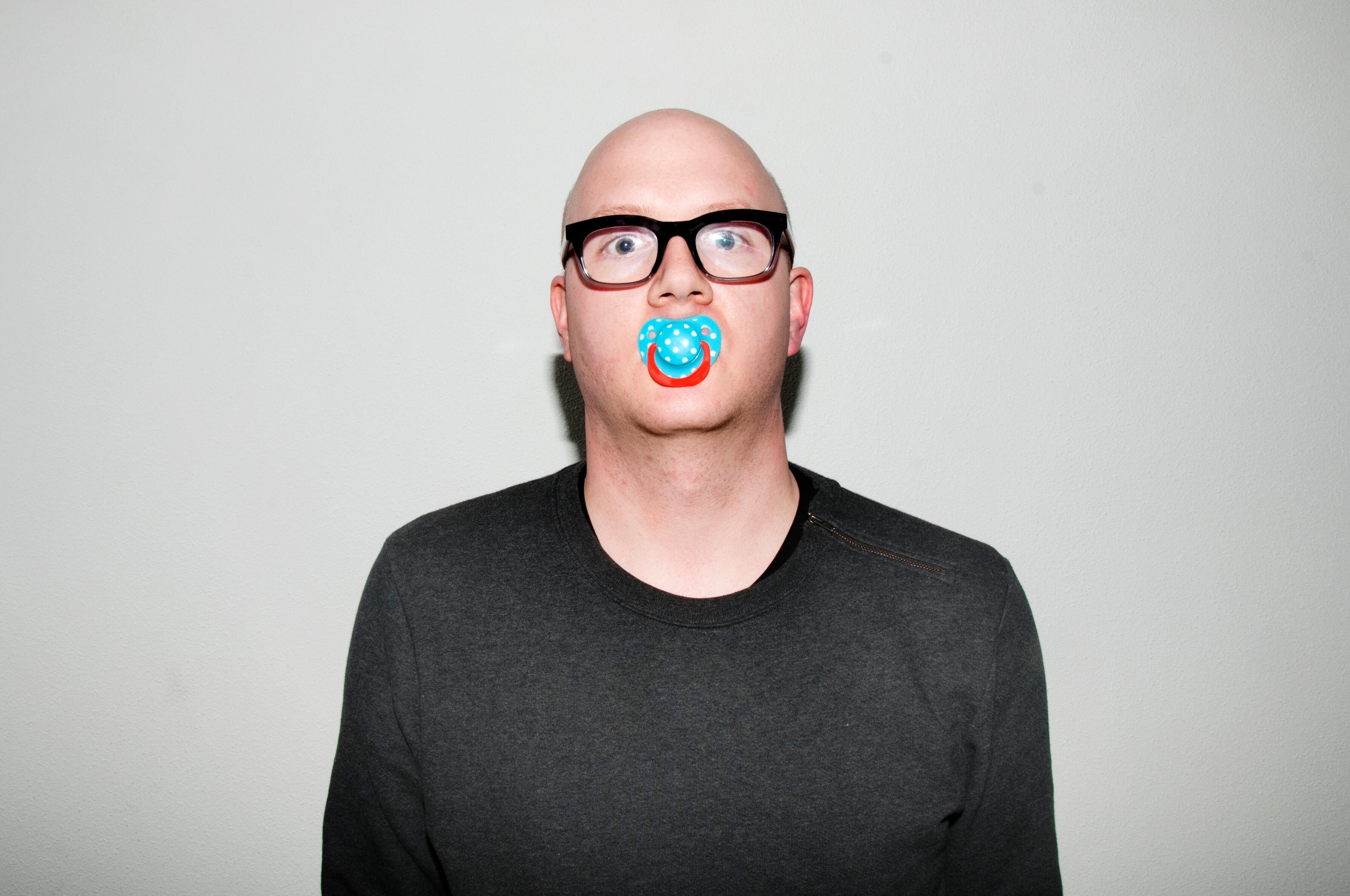 Acting like a baby, (self-)portrait of an adult wearing a dummy teat.