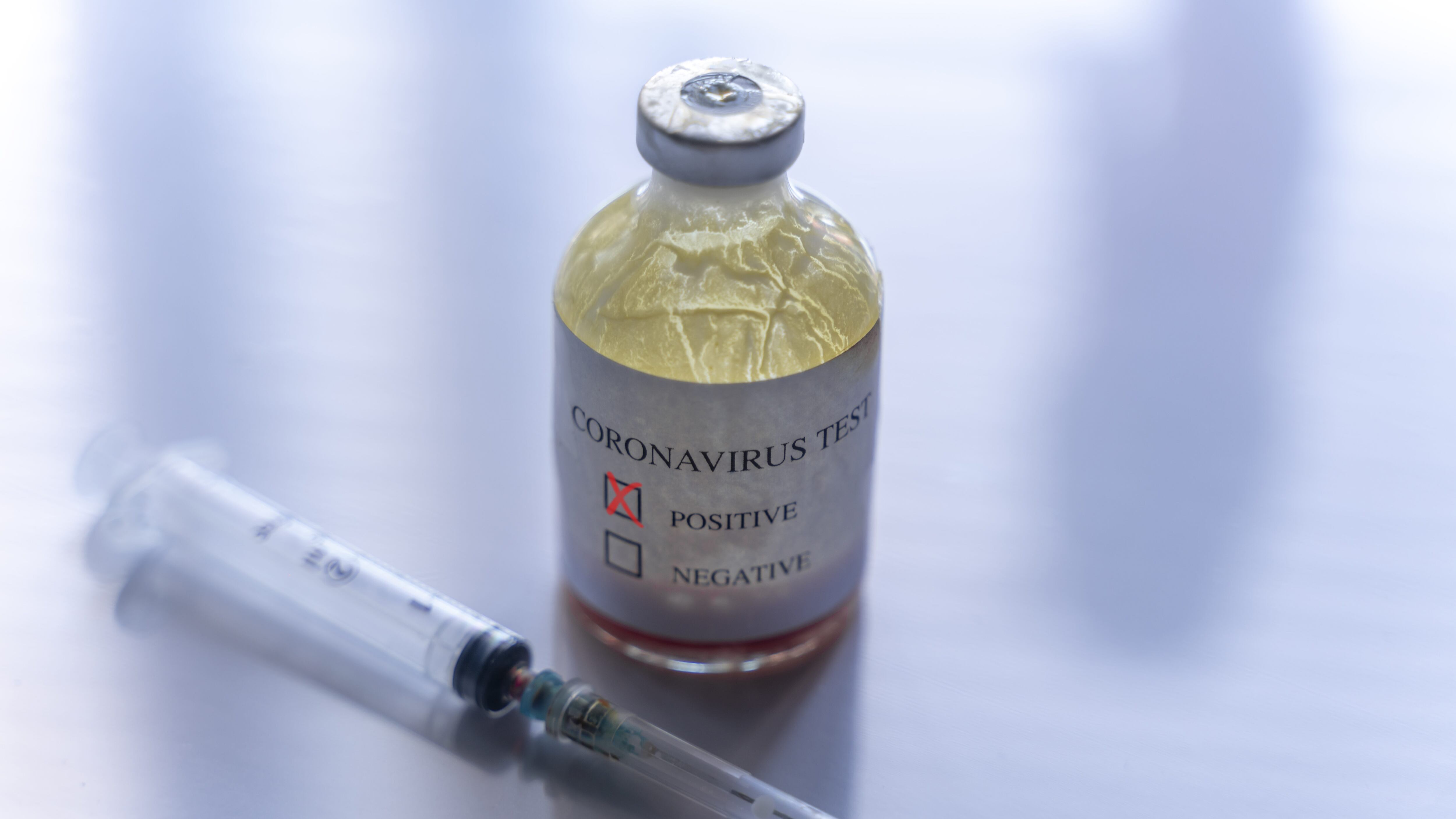 Syringe and ampoule containing coronavirus positive blood test