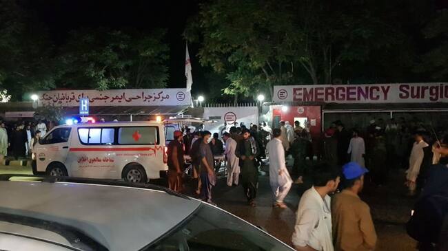 KABUL, AFGHANISTAN - AUGUST 26: Injured people being carried to a hospital as unspecified number of casualties reported after two explosions outside Hamid Karzai International Airport in Kabul, Afghanistan on August 26, 2021. (Photo by Sayed Khodaiberdi Sadat/Anadolu Agency via Getty Images)
