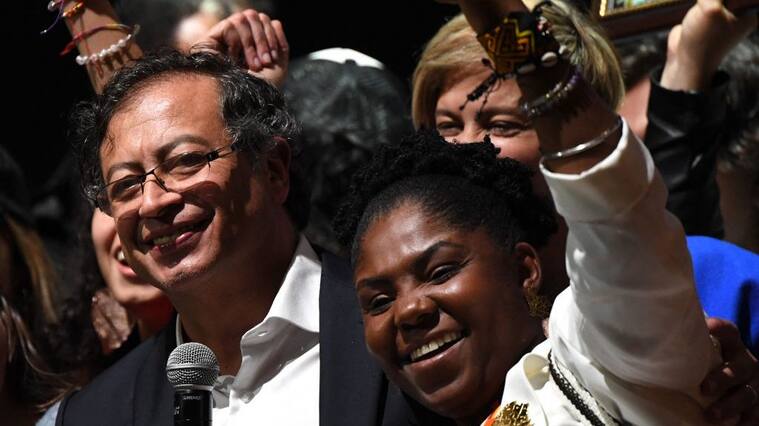 Newly elected Colombian President Gustavo Petro (L) and his running mate Francia Marquez (R) celebrate at the Movistar Arena in Bogota, on June 19, 2022 after winning the presidential runoff election on June 19, 2022. - Ex-guerrilla Gustavo Petro was on Sunday elected the first ever left-wing president of crisis-wracked Colombia after beating millionaire businessman rival Rodolfo Hernandez after a tense and unpredictable election. (Photo by Daniel MUNOZ / AFP) (Photo by DANIEL MUNOZ/AFP via Getty Images)