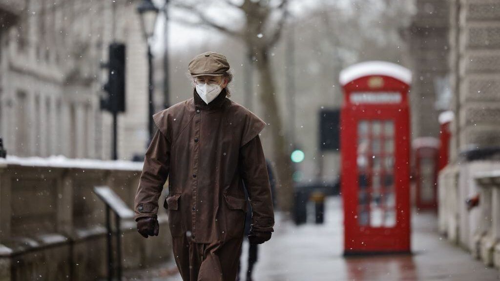 TOPSHOT - A man wearing a face mask because of the coronavirus pandemic walks in the street in London on February 8, 2021. (Photo by Tolga Akmen / AFP) (Photo by TOLGA AKMEN/AFP via Getty Images)