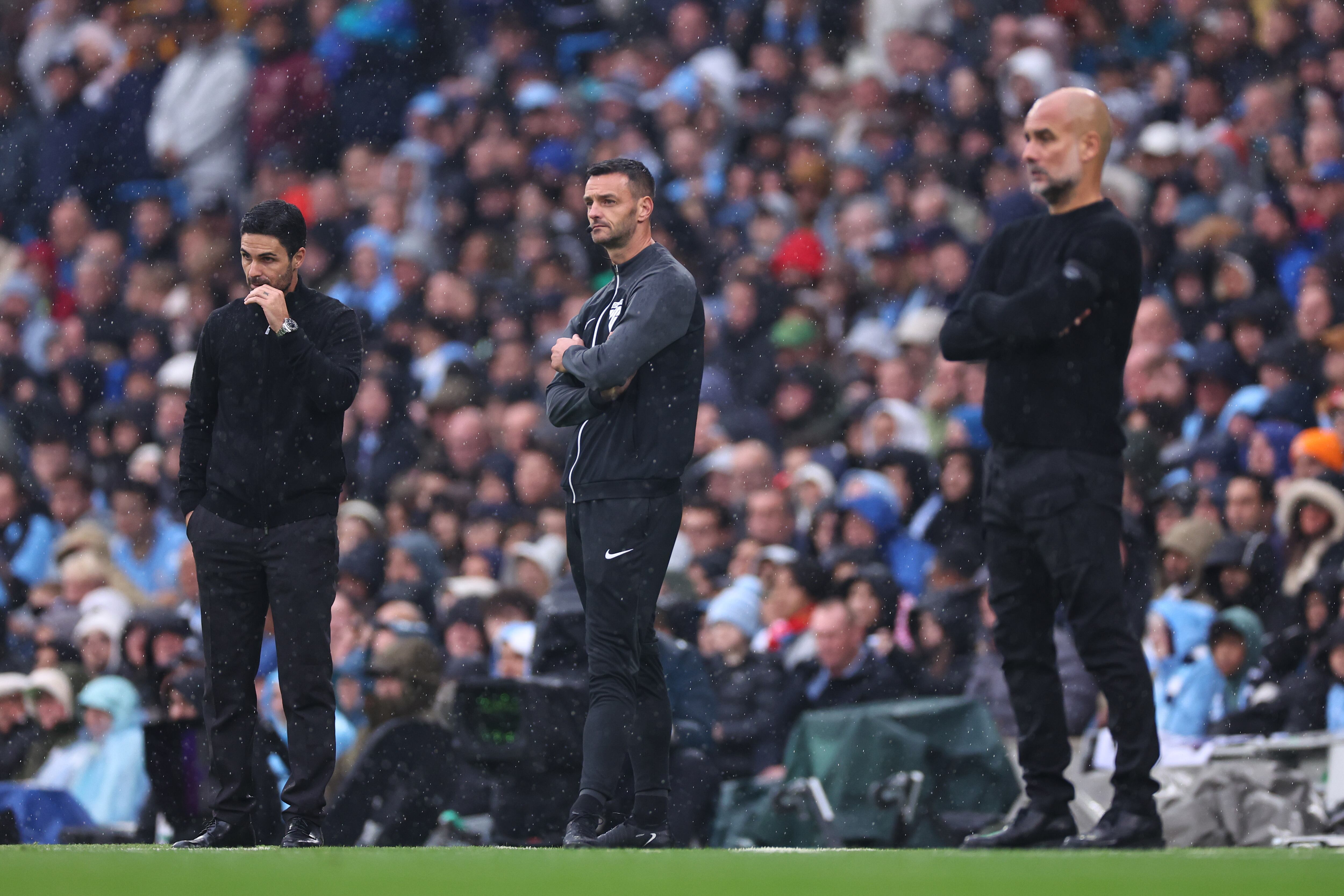 MANCHESTER, ENGLAND - SEPTEMBER 22: Pep Guardiola manager of Manchester City and Mikel Arteta manager / head coach  of Arsenal on the touchline during the Premier League match between Manchester City FC and Arsenal FC at Etihad Stadium on September 22, 2024 in Manchester, England. (Photo by Robbie Jay Barratt - AMA/Getty Images)