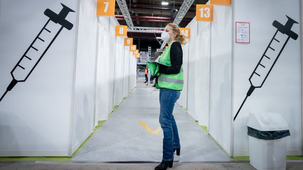 BERLIN, GERMANY - JANUARY 14: An assistant waits to help on the opening day at Berlin's second vaccine center in the Erika Hess Ice Stadium during the second wave of the coronavirus pandemic on January 14, 2021 in Berlin, Germany. Germany's vaccine program is picking up pace as infection and death rates continue to reach record highs. (Photo by Kay Nietfeld - Pool/Getty Images)