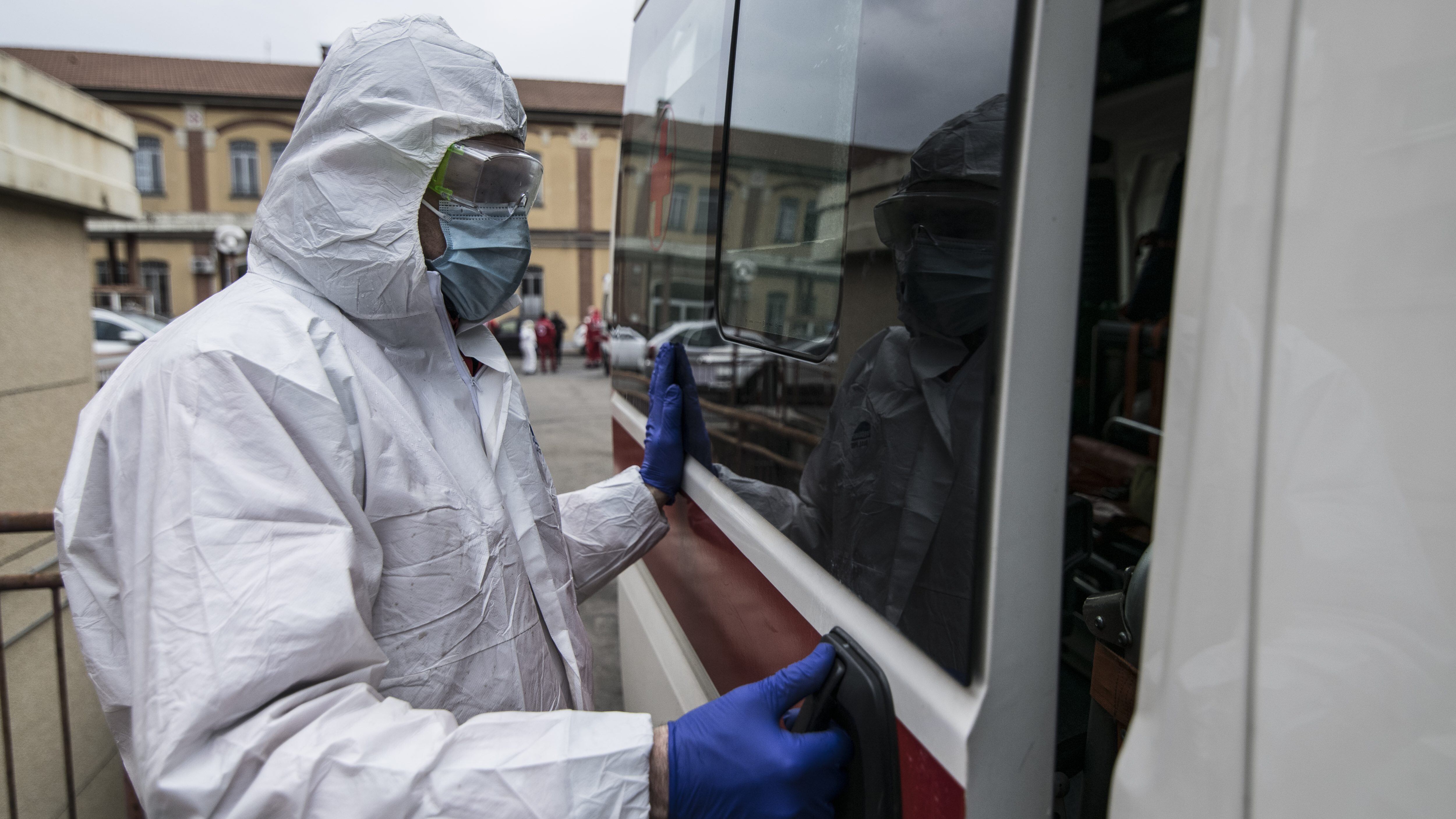 TURIN, ITALY - MARCH 25: Red Cross personnel in a protective containment suit prepares to go out with an ambulance for transportation on March 25, 2020 in Turin, Italy. The Italian government continues to enforce the nationwide lockdown measures to control the spread of COVID-19. (Photo by Stefano Guidi/Getty Images)
