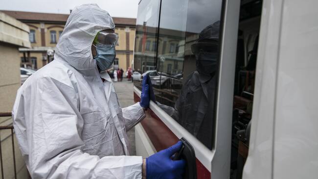 TURIN, ITALY - MARCH 25: Red Cross personnel in a protective containment suit prepares to go out with an ambulance for transportation on March 25, 2020 in Turin, Italy. The Italian government continues to enforce the nationwide lockdown measures to control the spread of COVID-19. (Photo by Stefano Guidi/Getty Images)