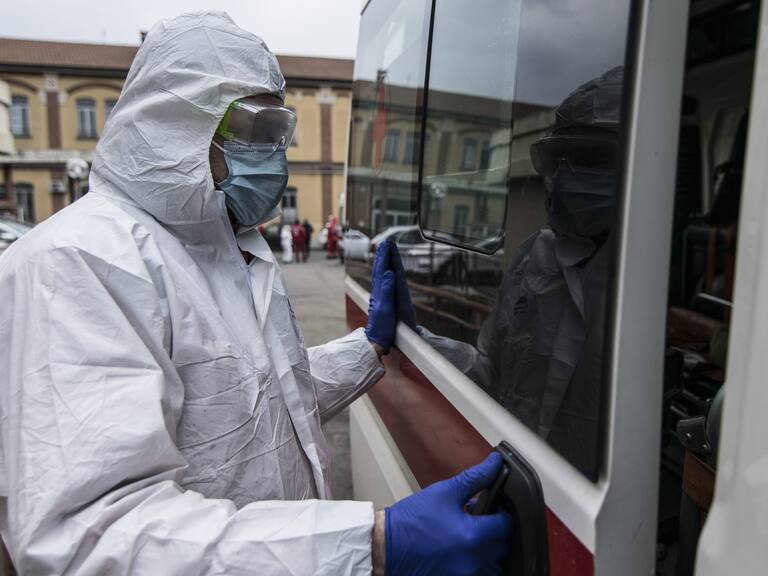 TURIN, ITALY - MARCH 25: Red Cross personnel in a protective containment suit prepares to go out with an ambulance for transportation on March 25, 2020 in Turin, Italy. The Italian government continues to enforce the nationwide lockdown measures to control the spread of COVID-19. (Photo by Stefano Guidi/Getty Images)