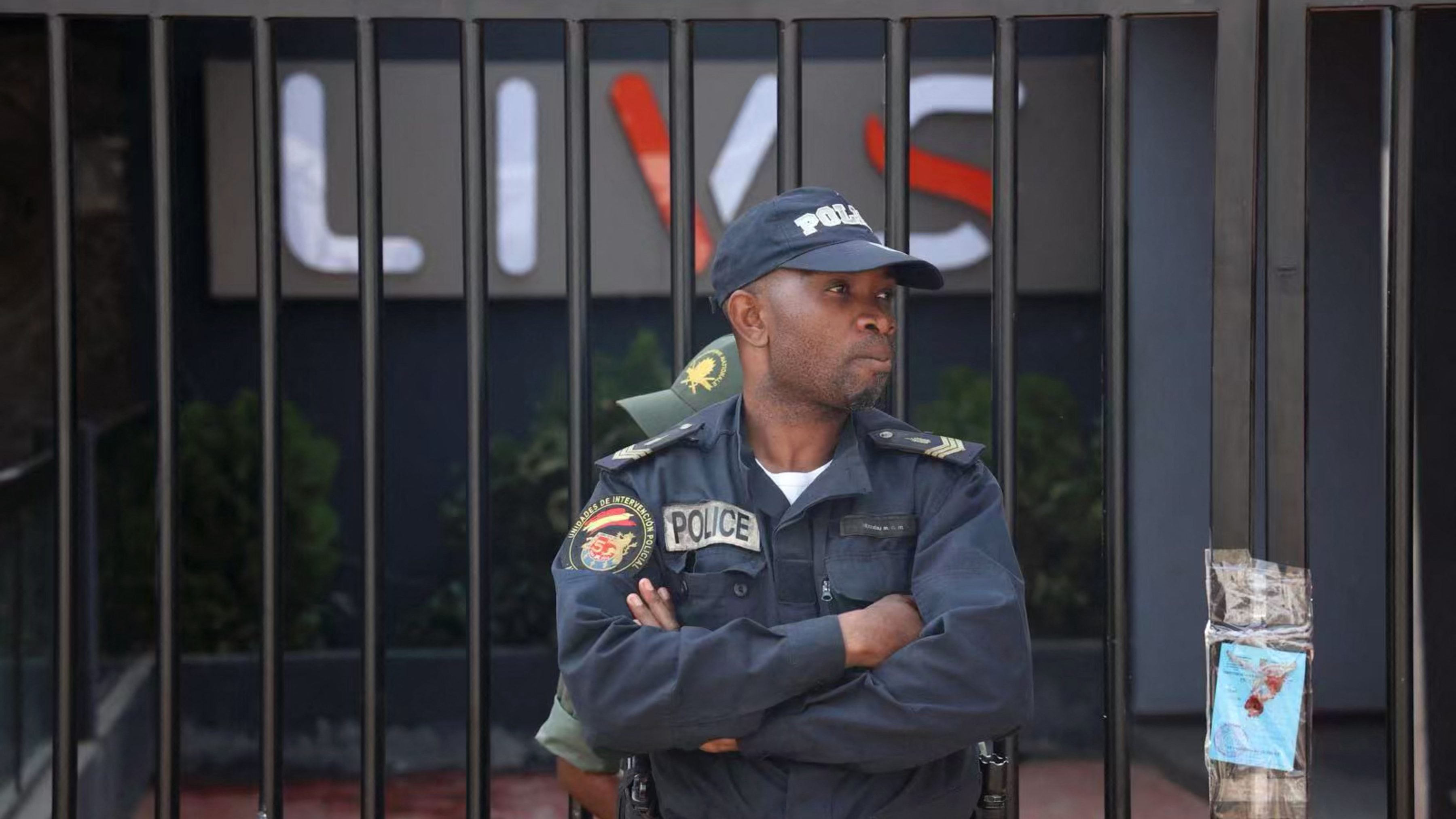 A policeman stands guard at the entrance of the Livs night-club where a deadly fire occured in the Bastos district of Yaounde, on January 23, 2022. - The accidental fire, caused by fireworks, killed at least 16 people. (Photo by Kenzo Tribouillard / AFP) (Photo by KENZO TRIBOUILLARD/AFP via Getty Images)