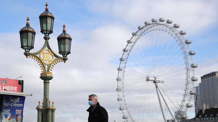 A man in a face mask in London, after Prime Minister Boris Johnson set out a new three-tier system of alert levels for England following rising coronavirus cases and hospital admissions. (Photo by Aaron Chown/PA Images via Getty Images)