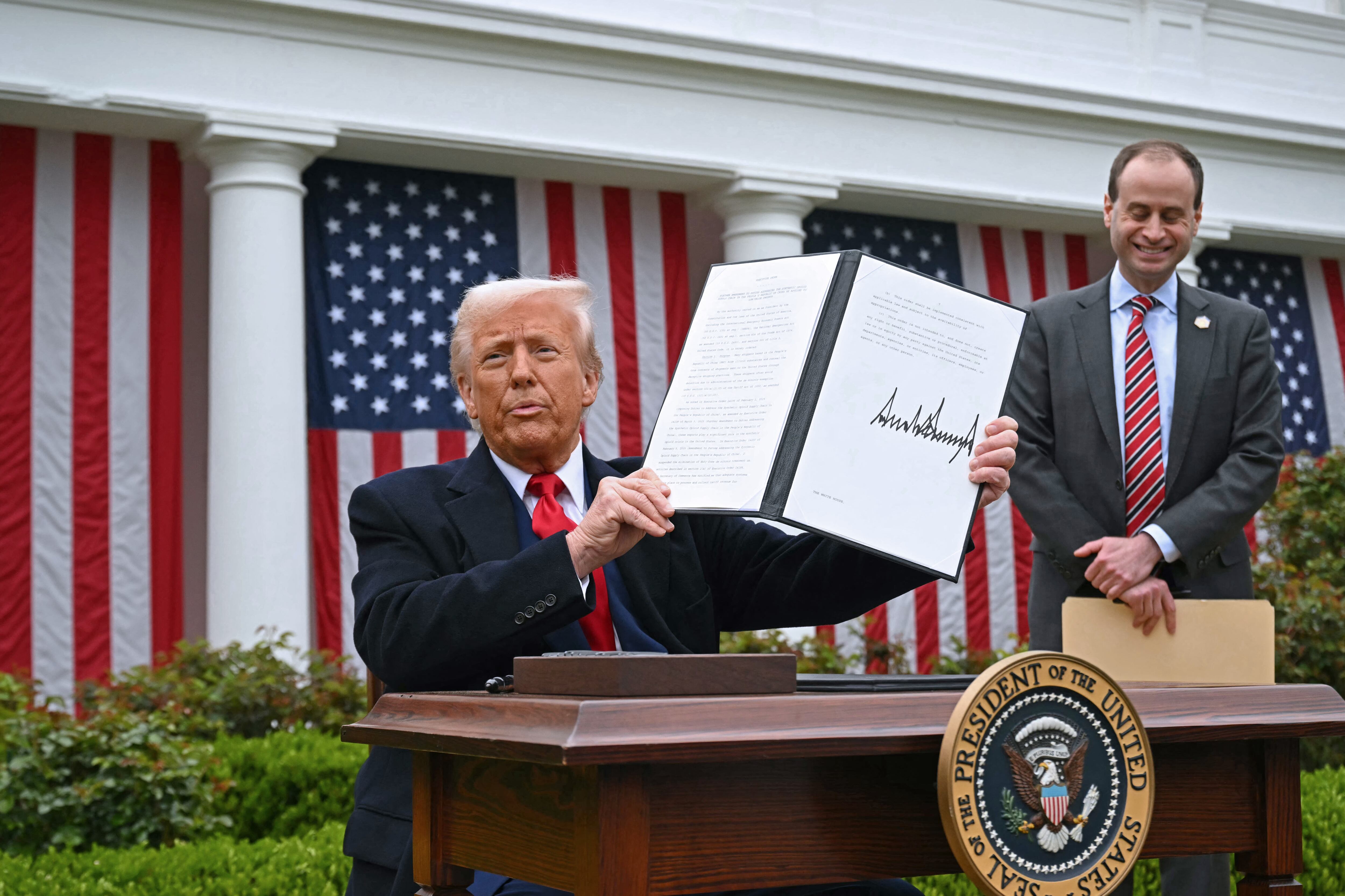 US President Donald Trump holds a signed executive order after delivering remarks on reciprocal tariffs during an event in the Rose Garden entitled "Make America Wealthy Again" at the White House in Washington, DC, on April 2, 2025. Trump geared up to unveil sweeping new "Liberation Day" tariffs in a move that threatens to ignite a devastating global trade war. Key US trading partners including the European Union and Britain said they were preparing their responses to Trump's escalation, as nervous markets fell in Europe and America. (Photo by SAUL LOEB / AFP) (Photo by SAUL LOEB/AFP via Getty Images)          