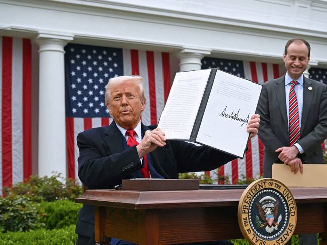 US President Donald Trump holds a signed executive order after delivering remarks on reciprocal tariffs during an event in the Rose Garden entitled "Make America Wealthy Again" at the White House in Washington, DC, on April 2, 2025. Trump geared up to unveil sweeping new "Liberation Day" tariffs in a move that threatens to ignite a devastating global trade war. Key US trading partners including the European Union and Britain said they were preparing their responses to Trump's escalation, as nervous markets fell in Europe and America. (Photo by SAUL LOEB / AFP) (Photo by SAUL LOEB/AFP via Getty Images)
