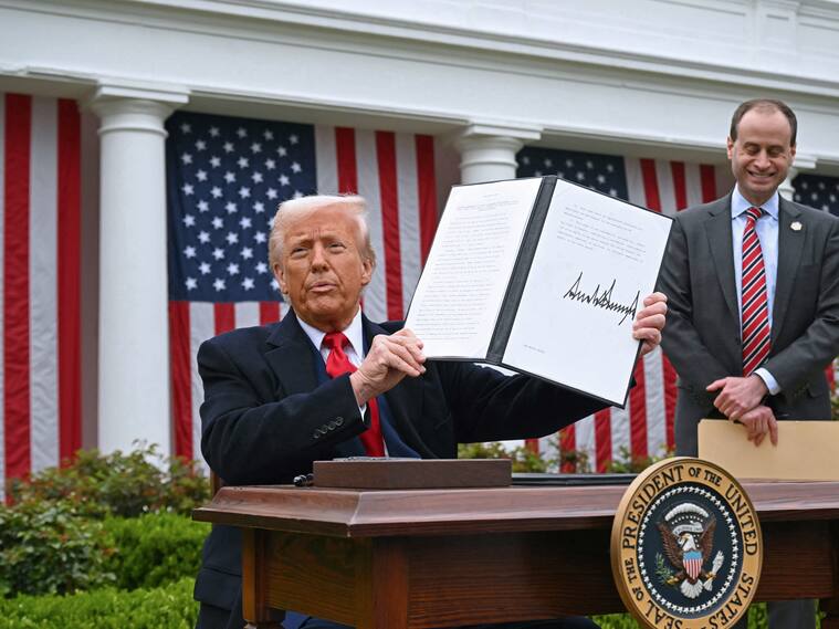 US President Donald Trump holds a signed executive order after delivering remarks on reciprocal tariffs during an event in the Rose Garden entitled "Make America Wealthy Again" at the White House in Washington, DC, on April 2, 2025. Trump geared up to unveil sweeping new "Liberation Day" tariffs in a move that threatens to ignite a devastating global trade war. Key US trading partners including the European Union and Britain said they were preparing their responses to Trump's escalation, as nervous markets fell in Europe and America. (Photo by SAUL LOEB / AFP) (Photo by SAUL LOEB/AFP via Getty Images)
