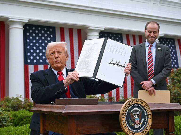 US President Donald Trump holds a signed executive order after delivering remarks on reciprocal tariffs during an event in the Rose Garden entitled "Make America Wealthy Again" at the White House in Washington, DC, on April 2, 2025. Trump geared up to unveil sweeping new "Liberation Day" tariffs in a move that threatens to ignite a devastating global trade war. Key US trading partners including the European Union and Britain said they were preparing their responses to Trump's escalation, as nervous markets fell in Europe and America. (Photo by SAUL LOEB / AFP) (Photo by SAUL LOEB/AFP via Getty Images)