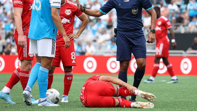 CHARLOTTE, NC - JUNE 11 Referee Guido Gonzales Jr talks to Ben Bender #15 of Charlotte FC after his foul on Luquinhas #82 of the New York Red Bulls during a game between New York Red Bulls and Charlotte FC at Bank of America Stadium on June 11, 2022 in Charlotte, North Carolina. (Photo by Andy Mead/ISI Photos/Getty Images)