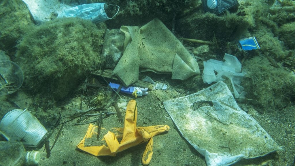 BECICI AND BUDVA, BUDVA MUNICIPALITY, MONTENEGRO - JULY 31, 2020: Plastic and other garbage polluting in the Adriatic Sea.  Used medical face masks discarded after COVID-19 on the beach and falls into the sea, drifts underwater along with plastic debris and settle at the bottom, approaching an ecological catastrophe. Discarded used medical face mask along with other plastic debris lies on the seabed.  - PHOTOGRAPH BY Andrey Nekrasov / Barcroft Studios / Future Publishing (Photo credit should read Andrey Nekrasov/Barcroft Media via Getty Images)