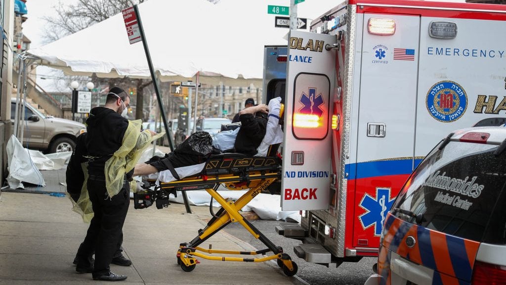 NEW YORK, USA - MARCH 25: A patient with a face mask is being carried to an ambulance at the Maimonides Medical Center in Brooklyn, New York, United States on March 25, 2020. The coronavirus-related deaths in the U.S. topped 800 on Wednesday, while the number of cases reached over 55,200, according to latest figures by Johns Hopkins University. (Photo by Tayfun Coskun/Anadolu Agency via Getty Images)