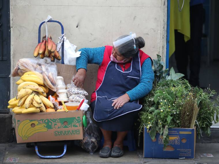 Una mujer vende alimentos en una calle de Lima