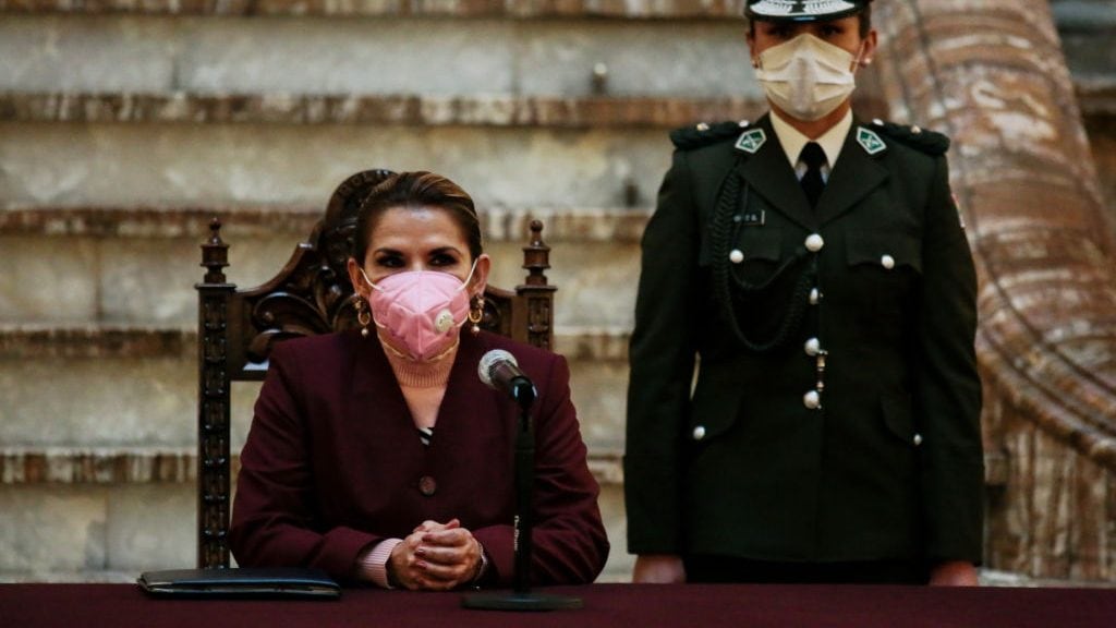 LA PAZ, BOLIVIA - AUGUST 13: Bolivian President Jeanine Añez wearing a facemask looks on during the presentation of the law amending the postponement of the 2020 general elections at Government's Palace on August 13, 2020 in La Paz, Bolivia. Interim President of Bolivia enacted the General Election Postponement Law at the Legislative Assembly which sets elections until October 18. General elections have been delayed twice citing coronavirus pandemic. Protests and roadblocks against the postponement continue in the country. (Photo by Gaston Brito/Getty Images)