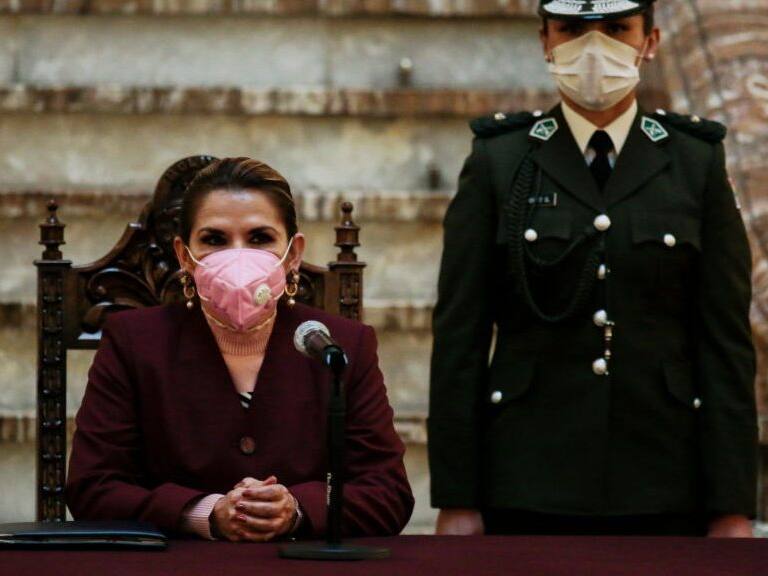 LA PAZ, BOLIVIA - AUGUST 13: Bolivian President Jeanine Añez wearing a facemask looks on during the presentation of the law amending the postponement of the 2020 general elections at Government&#039;s Palace on August 13, 2020 in La Paz, Bolivia. Interim President of Bolivia enacted the General Election Postponement Law at the Legislative Assembly which sets elections until October 18. General elections have been delayed twice citing coronavirus pandemic. Protests and roadblocks against the postponement continue in the country. (Photo by Gaston Brito/Getty Images)