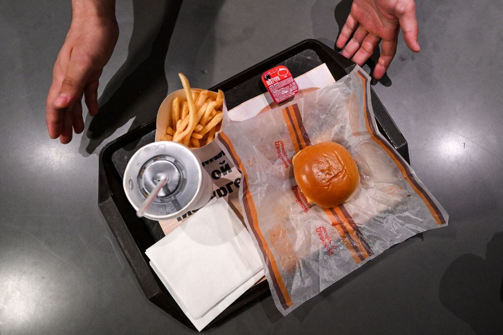 This photograph taken on on June 12, 2022 shows a double cheeseburger menu' including fries, sauce and a soft drink in the Russian version of a former McDonald's restaurant during the opening ceremony in Moscow . - Former McDonald's restaurants in Russia have been renamed "Vkusno i tochka" ("Delicious. Full Stop"), the new owner said ahead of their grand re-opening . (Photo by Kirill KUDRYAVTSEV / AFP) (Photo by KIRILL KUDRYAVTSEV/AFP via Getty Images)